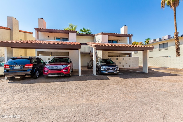 mediterranean / spanish home with a carport