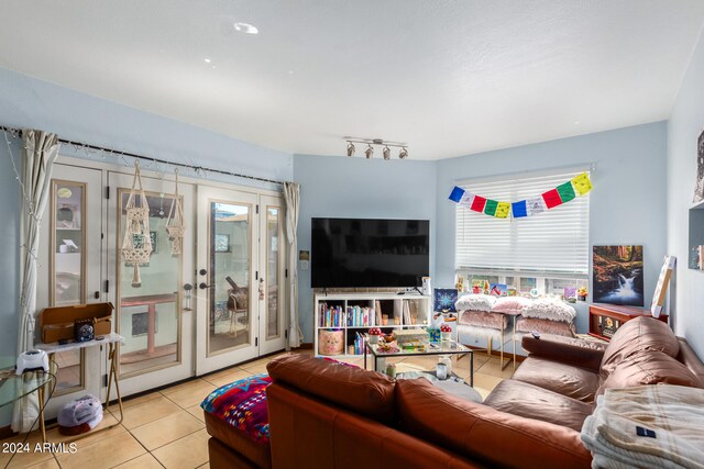 tiled living room featuring french doors