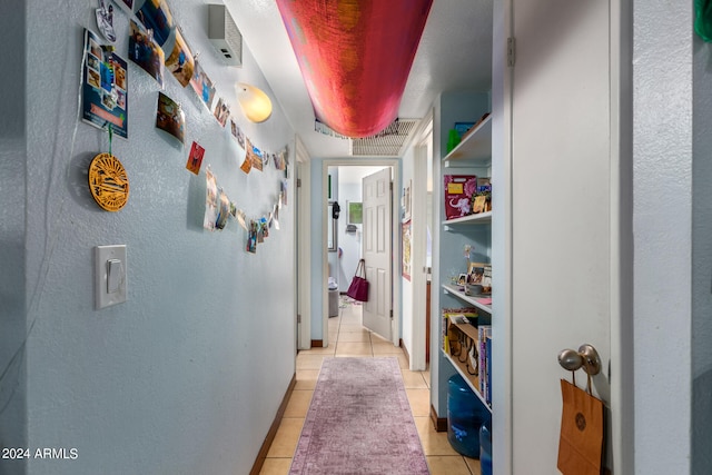 corridor with light tile patterned floors