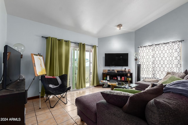 living room featuring lofted ceiling and light tile patterned floors