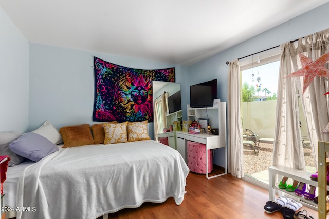 bedroom featuring hardwood / wood-style flooring and access to exterior