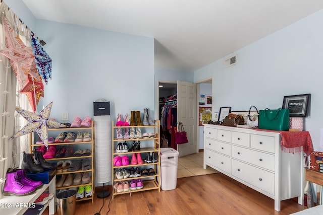 bedroom with wood-type flooring and a closet