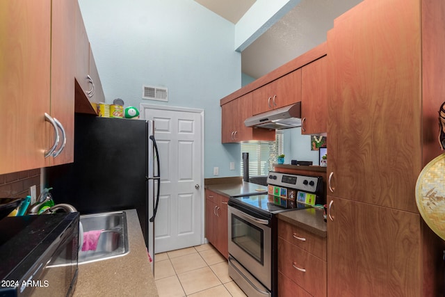 kitchen featuring stainless steel electric range oven and light tile patterned floors