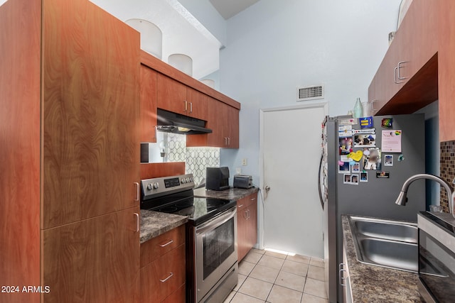 kitchen featuring decorative backsplash, stainless steel appliances, light tile patterned flooring, and sink