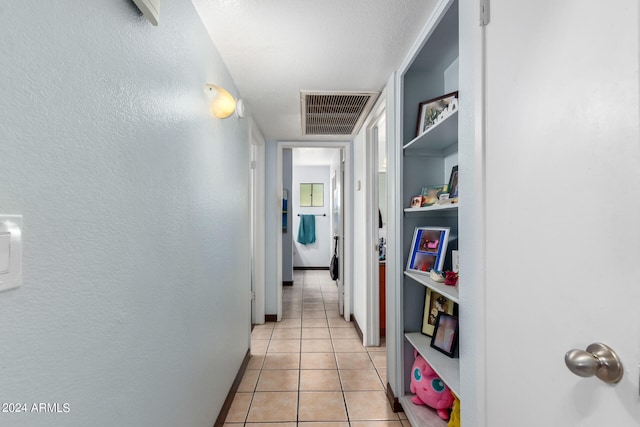 hallway featuring light tile patterned floors