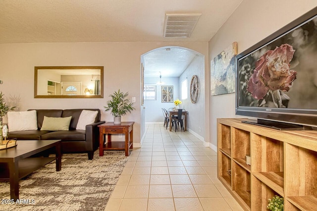 4905 E Horseshoe Ln, Cottonwood, AZ 86326 - living room featuring baseboards, visible vents, arched walkways, and light tile patterned floors