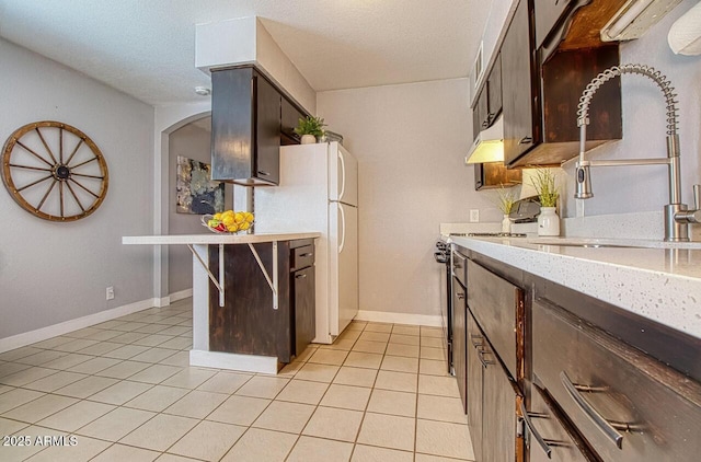 4905 E Horseshoe Ln, Cottonwood, AZ 86326 - kitchen with light tile patterned flooring, electric stove, a sink, and freestanding refrigerator