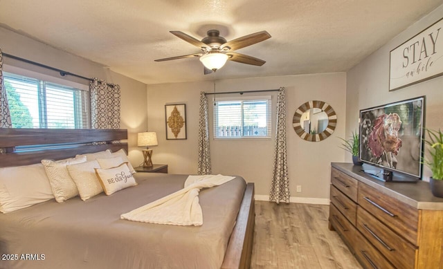4905 E Horseshoe Ln, Cottonwood, AZ 86326 - bedroom with a textured ceiling, wood finished floors, a ceiling fan, and baseboards