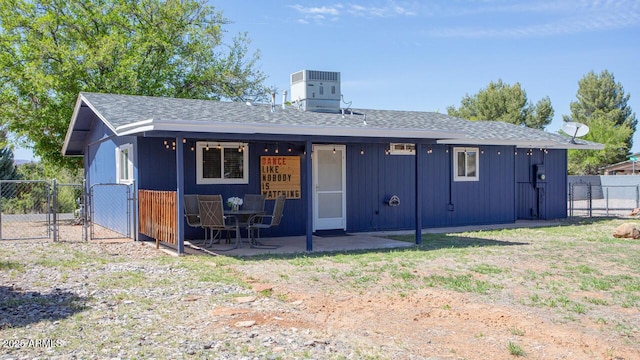 4905 E Horseshoe Ln, Cottonwood, AZ 86326 - rear view of house featuring a gate, a patio area, a shingled roof, fence, and central AC