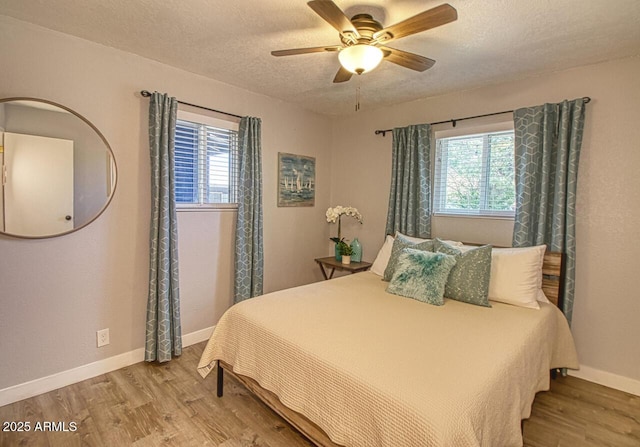 4905 E Horseshoe Ln, Cottonwood, AZ 86326 - bedroom featuring a textured ceiling, a ceiling fan, wood finished floors, and baseboards