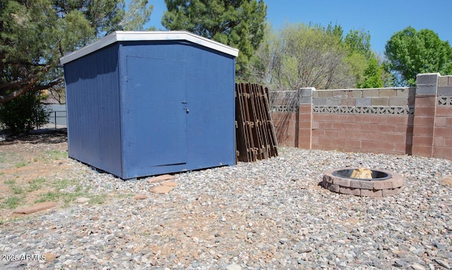 4905 E Horseshoe Ln, Cottonwood, AZ 86326 - view of shed with an outdoor fire pit and fence
