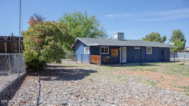 4905 E Horseshoe Ln, Cottonwood, AZ 86326 - back of property with roof with shingles, central AC unit, a fenced backyard, and a patio area