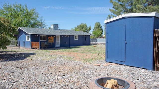 4905 E Horseshoe Ln, Cottonwood, AZ 86326 - exterior space with an outdoor fire pit, an outdoor structure, a fenced backyard, a storage shed, and cooling unit
