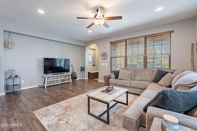 living room featuring dark hardwood / wood-style flooring and ceiling fan