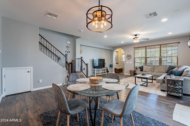 dining area with dark hardwood / wood-style flooring and ceiling fan with notable chandelier