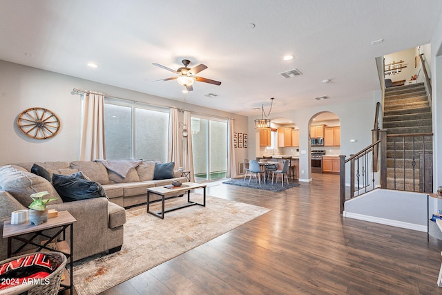 living room featuring dark hardwood / wood-style flooring and ceiling fan