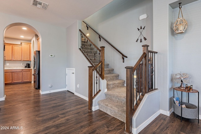 staircase with wood-type flooring