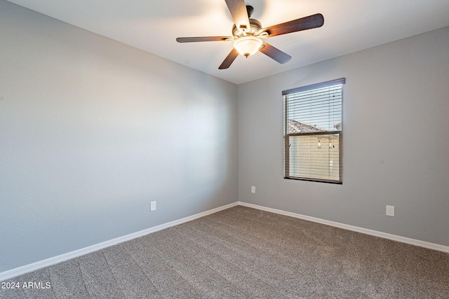 carpeted spare room featuring ceiling fan