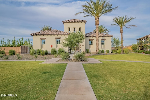 mediterranean / spanish-style home with a front lawn