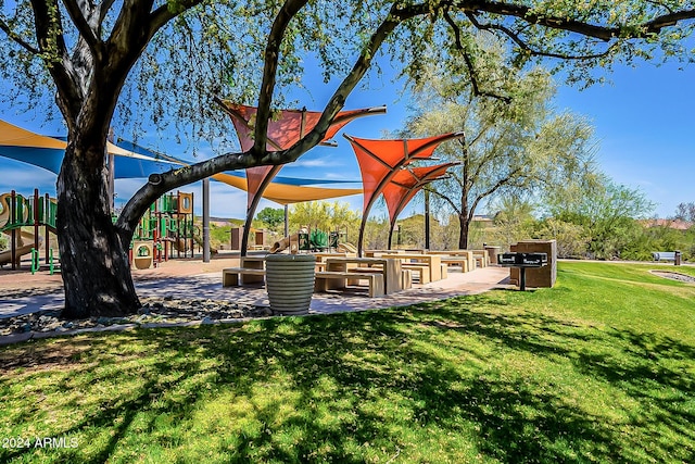 view of property's community with a yard and a playground