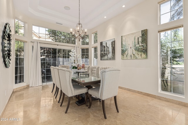 dining room with a notable chandelier and a high ceiling