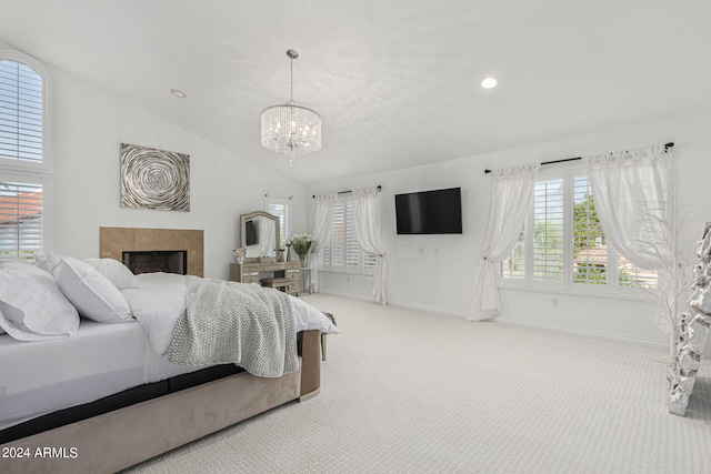 carpeted bedroom with an inviting chandelier and lofted ceiling