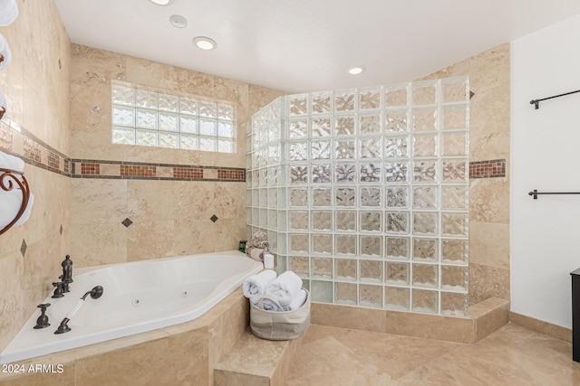 bathroom featuring tile walls, tile patterned flooring, and plus walk in shower