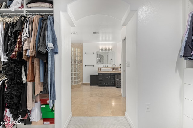 walk in closet with light tile patterned floors