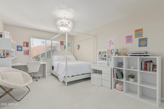 carpeted bedroom featuring an inviting chandelier