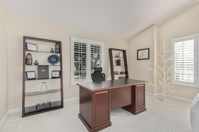 carpeted office featuring lofted ceiling