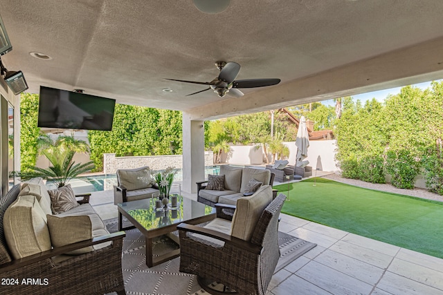 view of patio / terrace featuring ceiling fan, an outdoor hangout area, and a fenced in pool