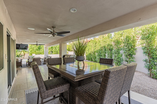 view of patio with ceiling fan and an outdoor living space