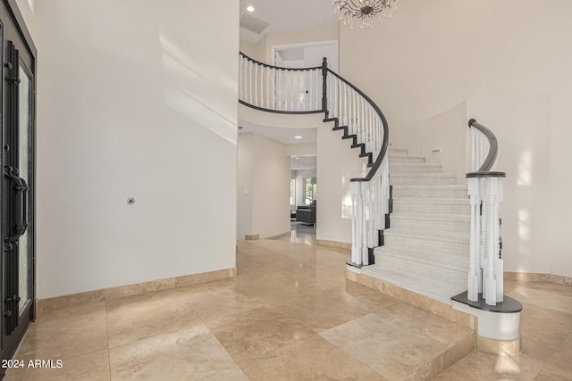 foyer entrance featuring a towering ceiling