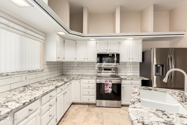 15602 N 19th St, Phoenix, AZ 85022 - kitchen with appliances with stainless steel finishes, sink, and white cabinets