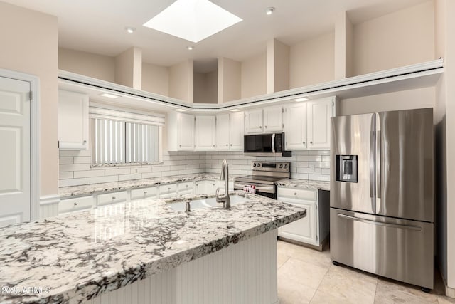 15602 N 19th St, Phoenix, AZ 85022 - kitchen featuring white cabinetry, stainless steel appliances, sink, backsplash, and light stone counters