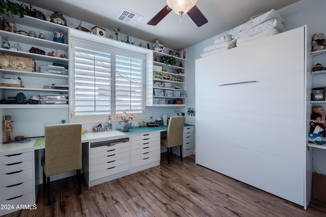 home office featuring hardwood / wood-style floors and ceiling fan