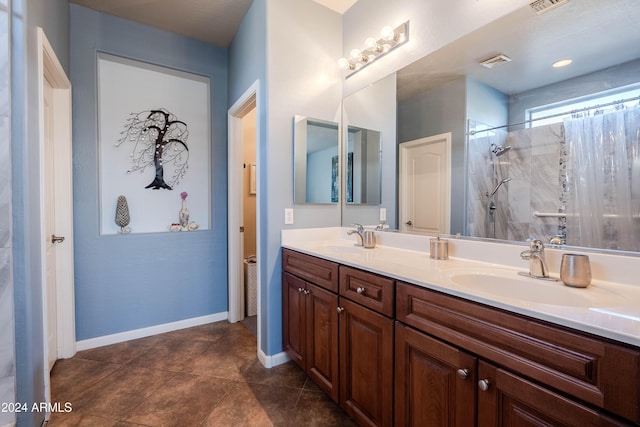 bathroom with a shower with curtain, vanity, and tile patterned floors