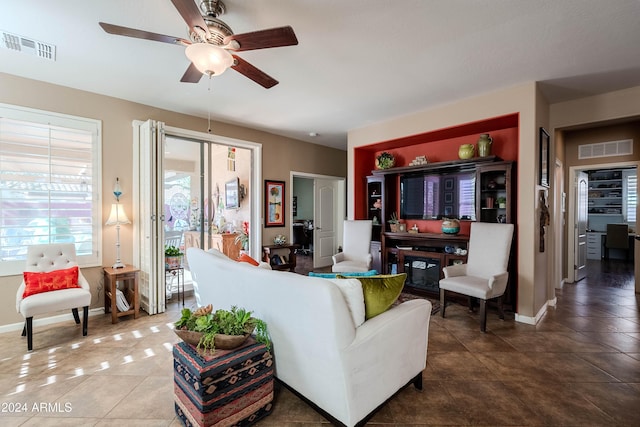 living room with tile patterned flooring and ceiling fan