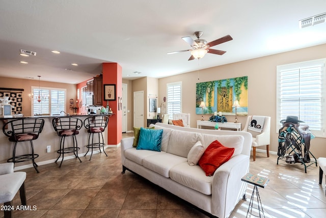 living room with tile patterned floors, a wealth of natural light, and ceiling fan