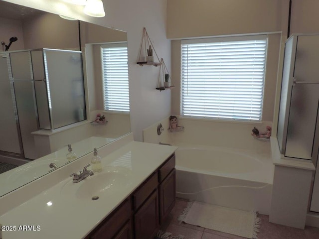 full bathroom with a stall shower, plenty of natural light, vanity, and a bath