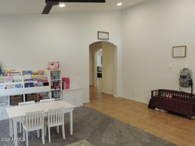 recreation room with a ceiling fan, arched walkways, recessed lighting, and tile patterned floors