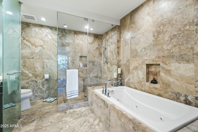 full bathroom with a whirlpool tub, a tile shower, toilet, and tile walls