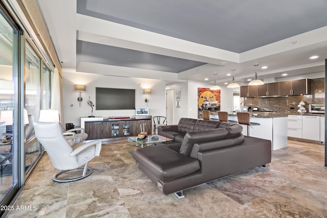 living area featuring recessed lighting and a tray ceiling