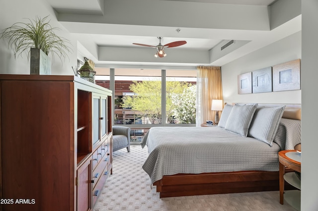 bedroom featuring carpet floors, ceiling fan, and floor to ceiling windows