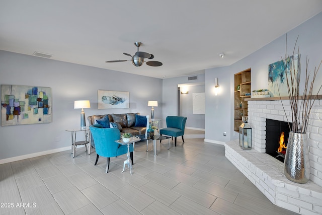 living room with a brick fireplace, tile patterned floors, and ceiling fan