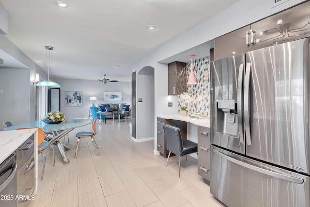 kitchen with ceiling fan, decorative light fixtures, and stainless steel appliances