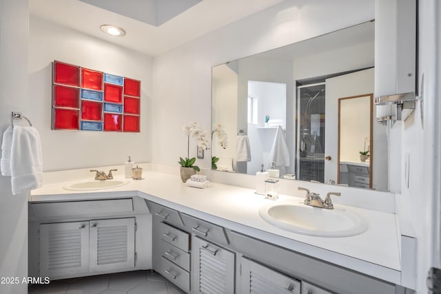 bathroom with tile patterned flooring, a shower, and vanity