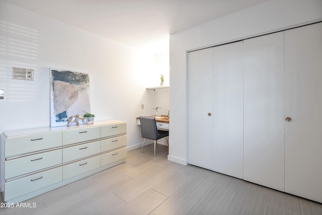 bedroom with a closet and built in desk