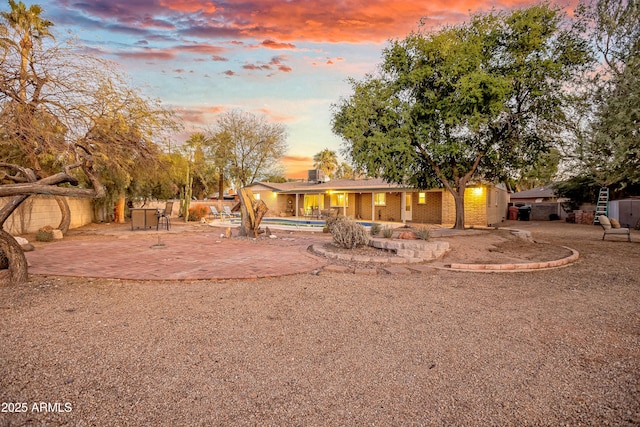 exterior space with a pool and a patio