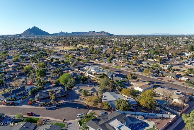 birds eye view of property with a mountain view